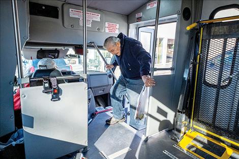 fter shopping at The Corner Store, Whitehall resident Bruce Ball boards a Whitehall Public Transportation bus driven by  LeRoy Murphy Feb. 21, 2020. (Ball has since passed away.) 