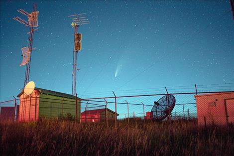 The comet NEOWISE can be seen above to the right of the radio tower in Polson's night sky.