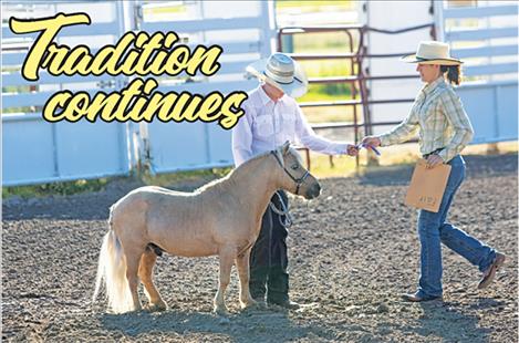 A competitor is awarded a first-place ribbon in the mini-horse category at the Lake County Fair on Saturday