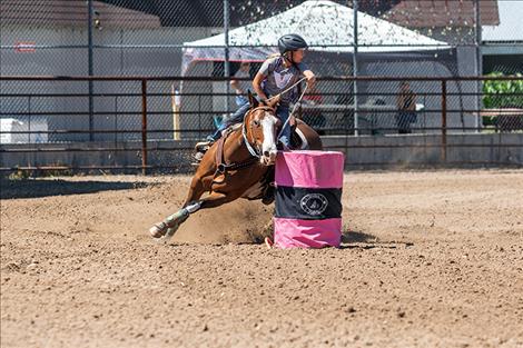 Brielle  Zempel rounds the second barrel and sets her eyes on the third during the barrel racing event at the Lake County Fairgrounds.