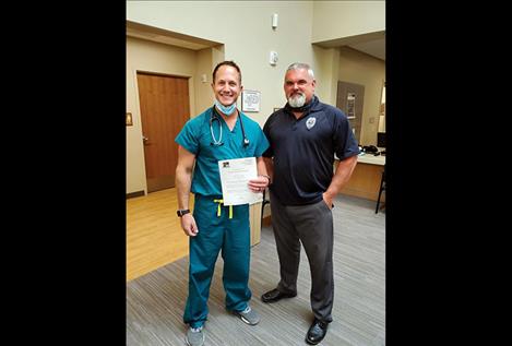 Polson Police Department Chief Wade Nash presents an award to Michael Schallock.