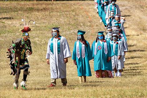 Two Eagle River School graduates are honored during a ceremony on Saturday. 