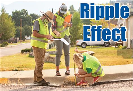 David Sturman, Mikaela Richardson and Lina Sturman collect storm drain data. 