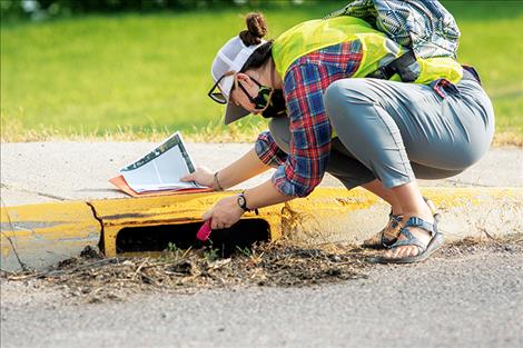 Mikaela Richardson inspects a stormwater drain.