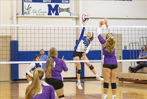 Lady Bulldog Sydney Brander returns a volley.