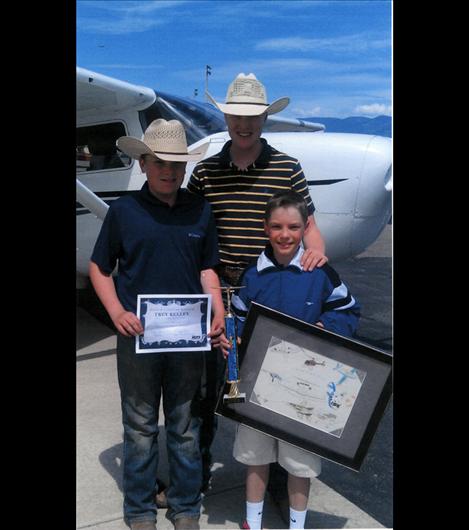 Willy, left, and Wyatt Lytton, center, stand with Trey Kelley. The Lytton boys, with support from their parents, started the Blue Skies Aviation program and promoted the art contest.