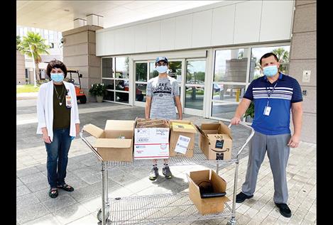 lehealth Access for Seniors co-founder Arjun Verma (center) delivers devices with Chief of Voluntary Services Adelina Sowell and hospital staffer Ed Molina at the Lake Nona VA Medical Center in Orlando, Florida.