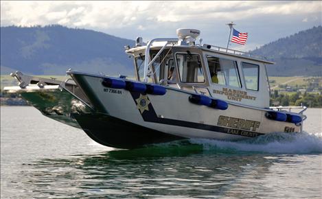 Sergeant Glenn Miller drives the new Lake County Sheriff’s Office boat on Flathead Lake during training.