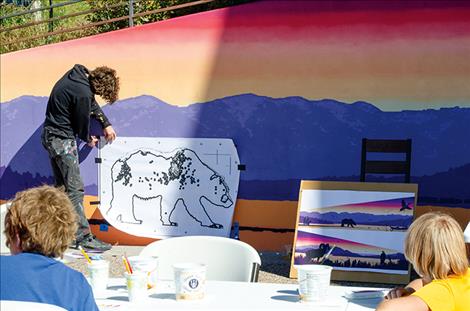 The artist of the Flathead Lake mural shares his work with children on Friday. 