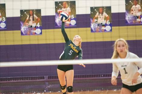 Lady Pirate Hallie Moss fires a serve over the net.