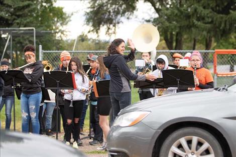 The RHS band plays the school’s fight song along the roadside during the reverse homecoming parade.