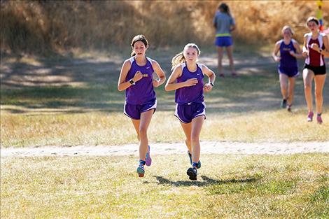 Two Lady Pirate runners race toward the finish line.