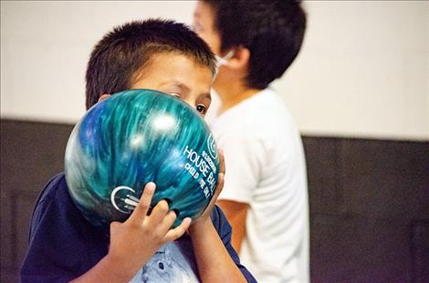 Jaycen Powell, 6, looks down the lane to line up his shot. 