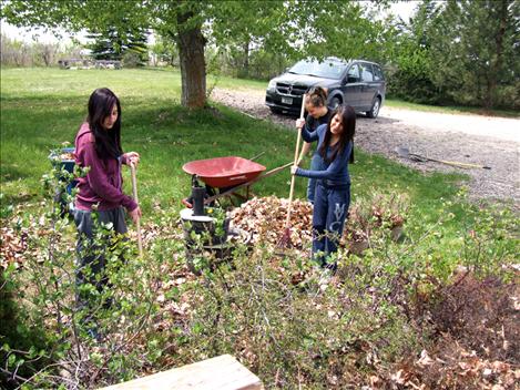 Mission Valley students clean flower beds at Sue and Jack Dunn’s home near Big Arm.