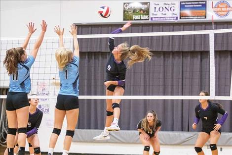 Lady Viking Carlee Fryberger battles at the net.