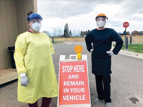 Tanisha Matt and Leona Spittler were poised to conduct curbside COVID-19 tests in the parking lot at St. Luke Hospital in Ronan last week.