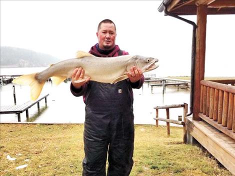 Angler Tony Incashola, Jr. proudly displays his prized catch.