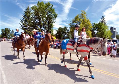 Following Old Glory in Charlo’s parade, a true “paint” horse boasts the stars and stripes. 