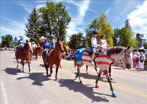 Following Old Glory in Charlo’s parade, a true “paint” horse boasts the stars and stripes.
