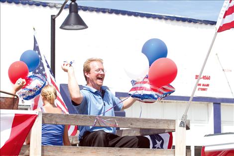 Jim Siragusa throws candy from Super One's float in Polson's 4th of July parade.