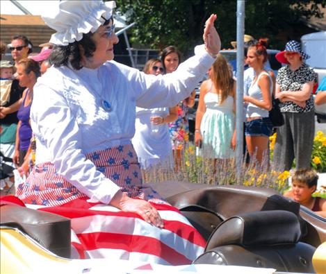Bonnie Manicke, grand marshal of Polson's 4th of July parade, waves to spectators.