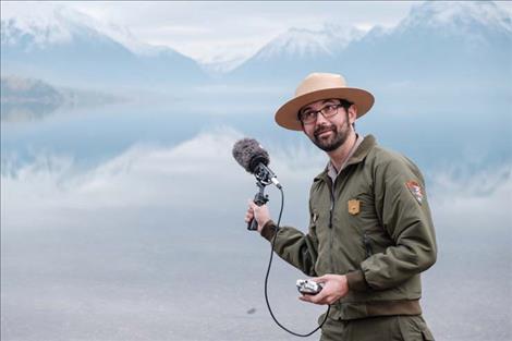 Headwaters Podcast host Michael Faist records audio of Lake McDonald with a shotgun mic.