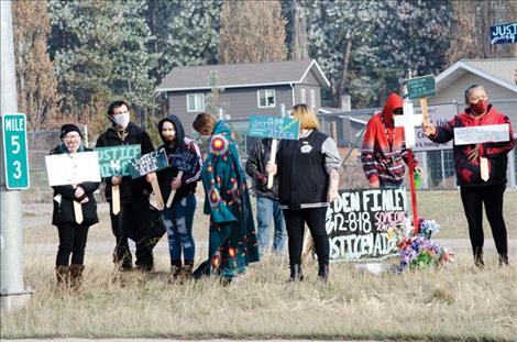  People gather to share a message,  “Justice for Aiden,” on U.S. Highway 93 in Pablo