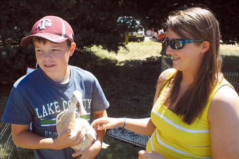 Monica with 4-H youth Phillip Vaughan and his project duck.