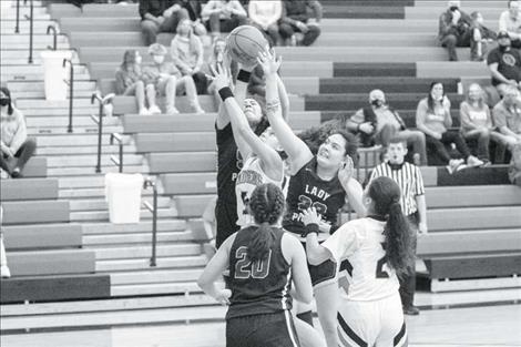 Rob Zolman / Valley Journal The Polson Lady Pirates and Ronan Maidens battle under the basket for a rebound.     