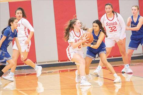 Arlee Scarlet Xaria Jacobson battles Mission Lady Bulldog Kooper Page for the ball. 