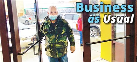 Robert Davis heads in to Mission Mountain Natural Foods on Main Street Monday morning. After the resort tax failed to pass during the election, Polson shopping will stay the same. 