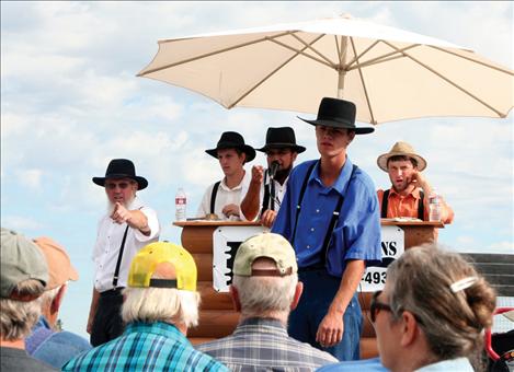 Auctioneers take bids on an anvil that eventually sold for $100.