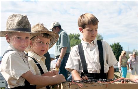 Young Amish lads oversee chickens during Saturday's auction.