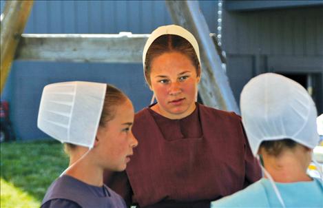 Sara Yoder, 10, Kristina Brenneman, 12, and Emily Miller, 9 wait for customers at their ice cream stand.