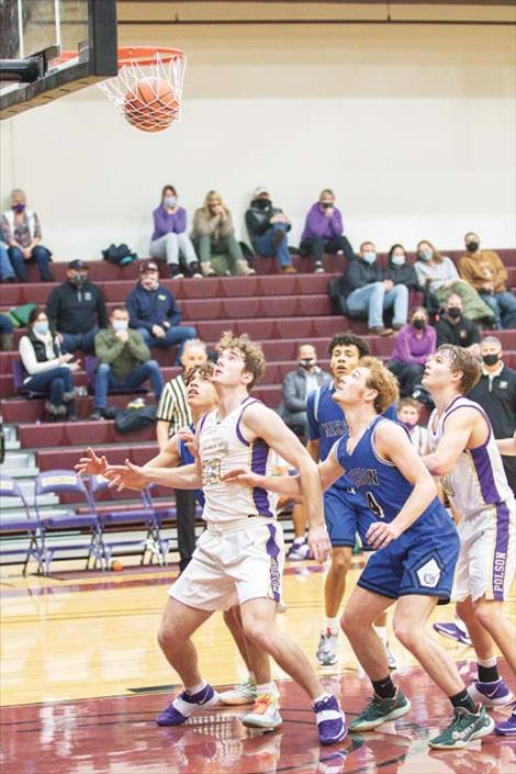 Bulldog and Pirate players prepare to battle for a rebound. 