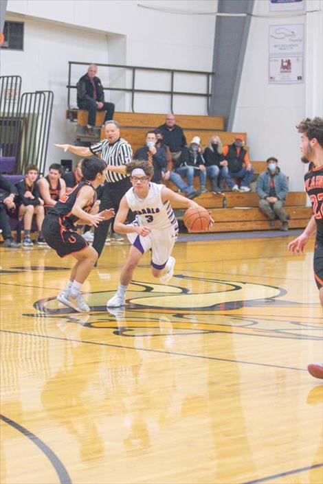 Charlo Viking Phil Marquez works his way down court during the opening rounds of the District 14C boys basketball tournament. 