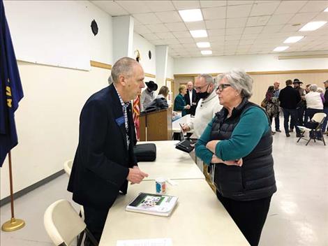 Sen. Greg Hertz, of Polson, visits with constituent Ronna Walchuk following last Thursday’s legislative update at the Ronan Community Center.