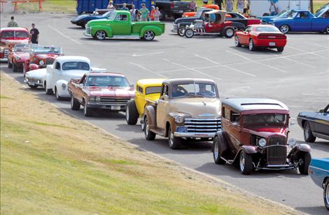 Classic cars line the parking lot at Riverside Park in Polson as drivers wait to cruise Rocky Point Road and Jette Hill.