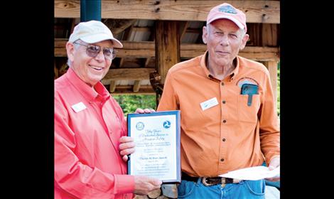 Chuck Jarecki, right, accepts the Wright Brothers Master Pilot Award from Dan Prill.