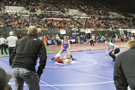 Isaiah Allik celebrates a match victory during the 2019-2020 Class B/C state wrestling tournament.