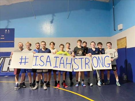 The 2020-21 Mission/Charlo Bulldogs wrestling team show their support for Isaiah.