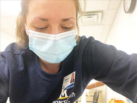 A friendly Montana State University nursing student, Haley, gives Kristi Niemeyer her second dose of the COVID-19 vaccine. 