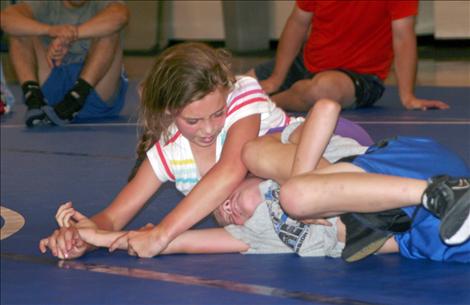 Maggi Lake wrestles her opponent during the Iron Dog Wrestling Camp held last week in St. Ignatius.