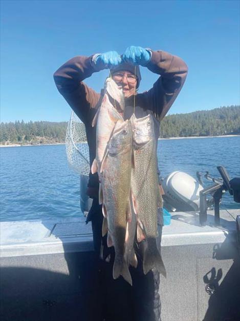 Julie Perkins holds up her and Terry Krogstad’s bucket entry of 30.3 lbs of lake trout.