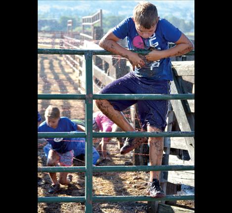 Kale Korella climbs a fence ahead of family members.