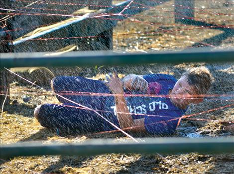 Kale Korella rolls through the wet maze of baling twine during the first annual Mud Run fundraiser for the Boys and Girls Club of the Flathead Reservation and Lake County.