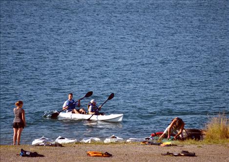 Mud Run participants kayak Flathead River for a portion of the race.