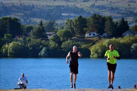 Mark Murphree and Rob LaBair jog up from the Flathead River.