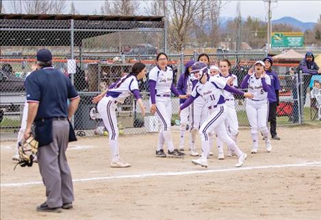 Polson Lady Pirate slugger Lexie Orien celebrates a game tying home run with teammates.