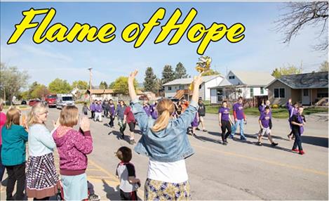 Students and staff from Cherry Valley Elementary cheer open Special Olympians as they pass by.